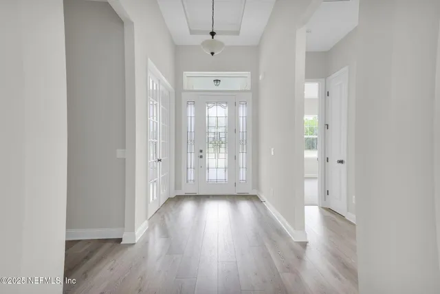 a view of a hallway with wooden floor
