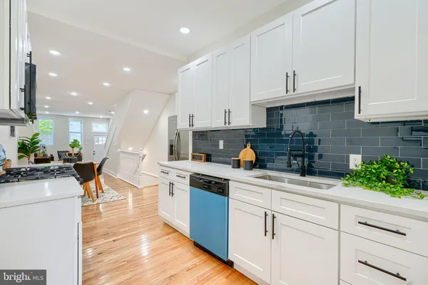 a kitchen with stainless steel appliances kitchen island granite countertop a sink and cabinets