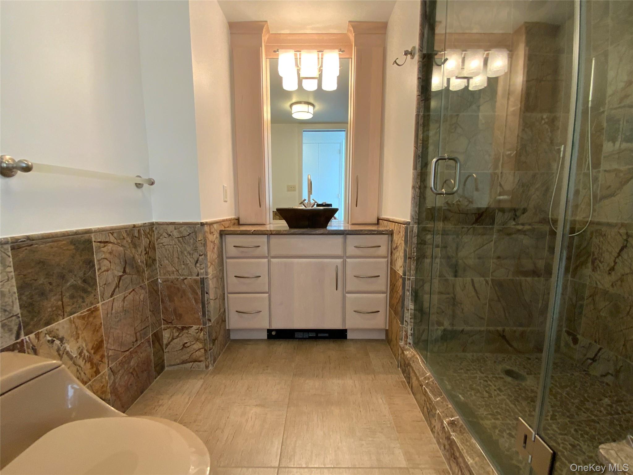 269 Grand Central Parkway, Unit 32O Queens, NY 11005 - Photo 14 of 33 a bathroom with a sink a toilet and shower