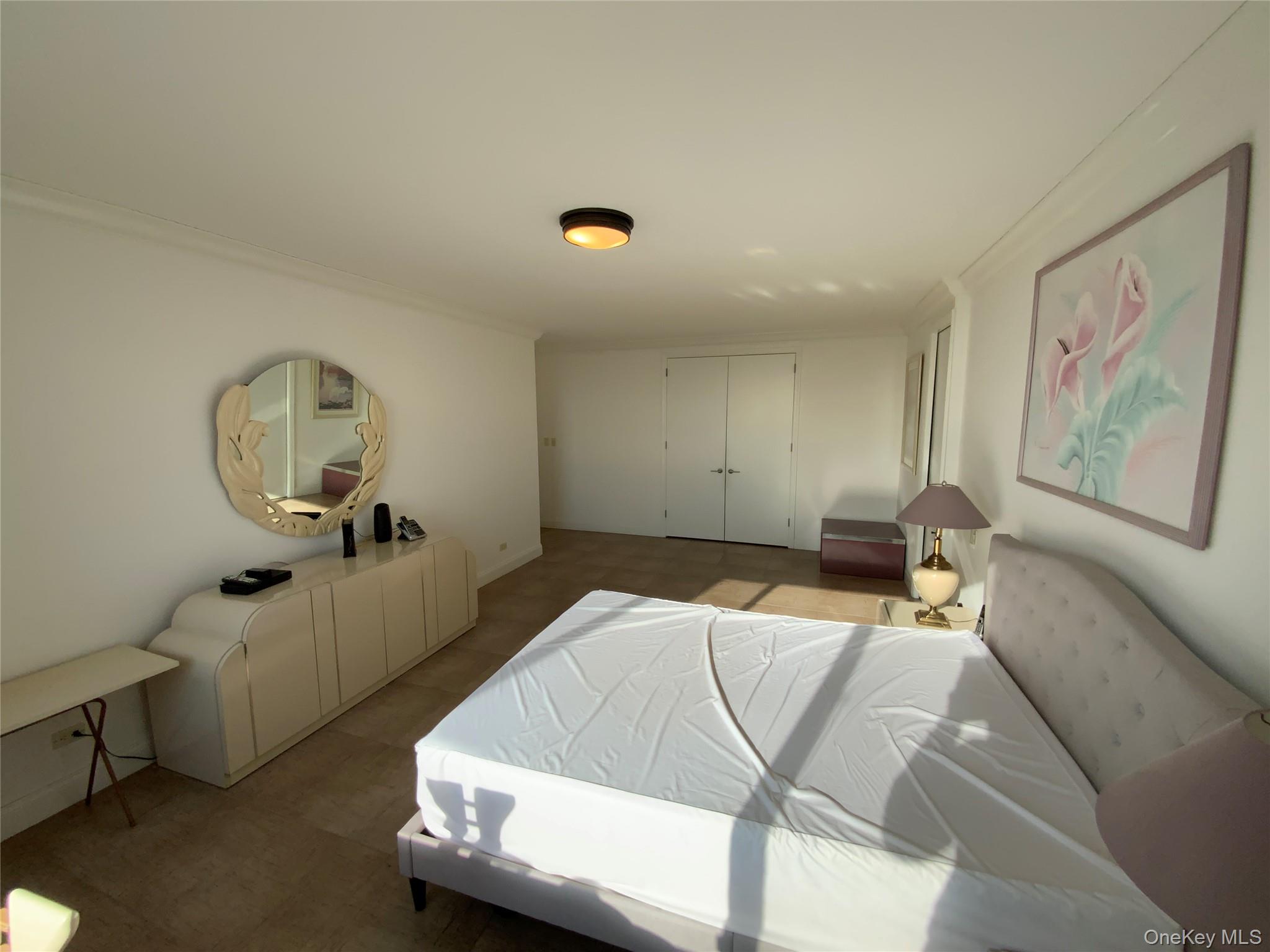 269 Grand Central Parkway, Unit 32O Queens, NY 11005 - Photo 16 of 33 a bedroom with a bed and a dresser