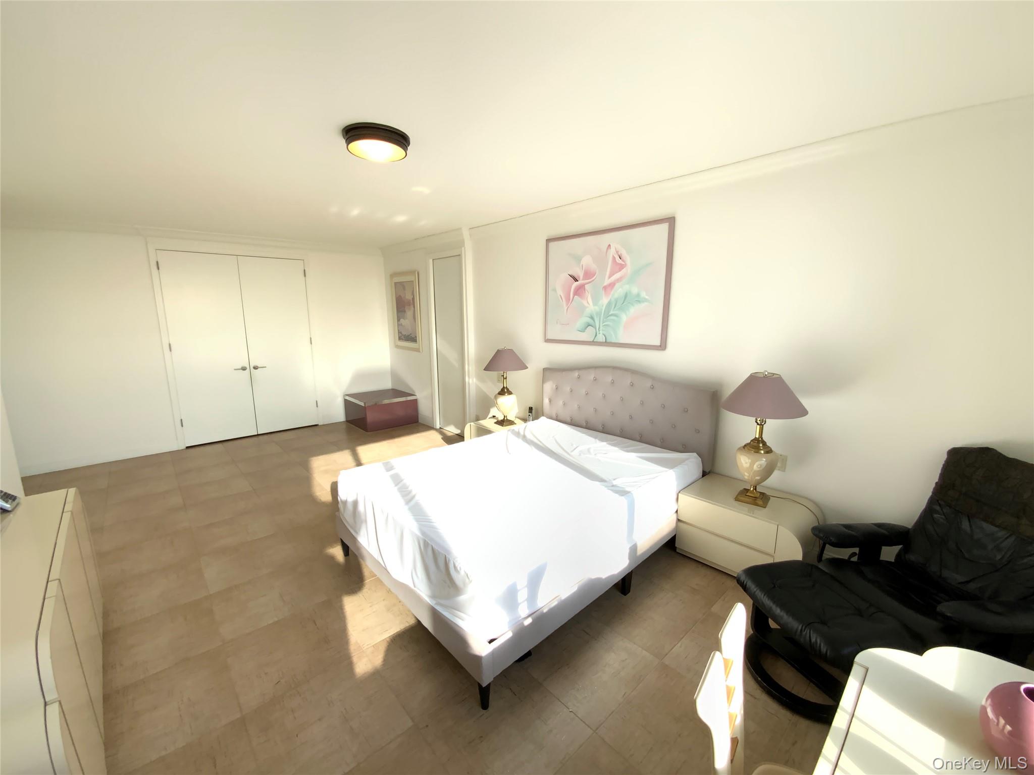 269 Grand Central Parkway, Unit 32O Queens, NY 11005 - Photo 18 of 33 a bedroom with a bed and a couch