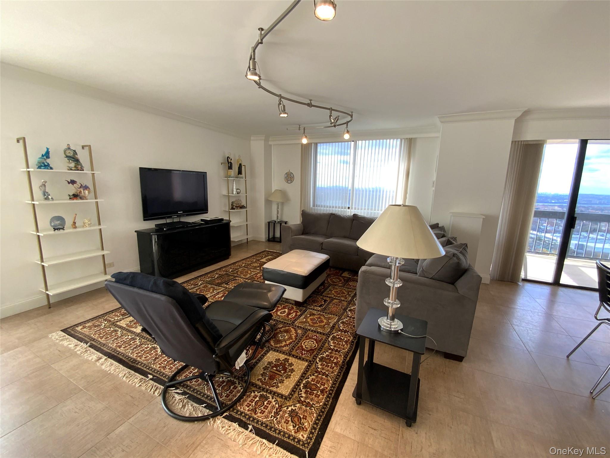 269 Grand Central Parkway, Unit 32O Queens, NY 11005 - Photo 2 of 33 a living room with furniture and a flat screen tv