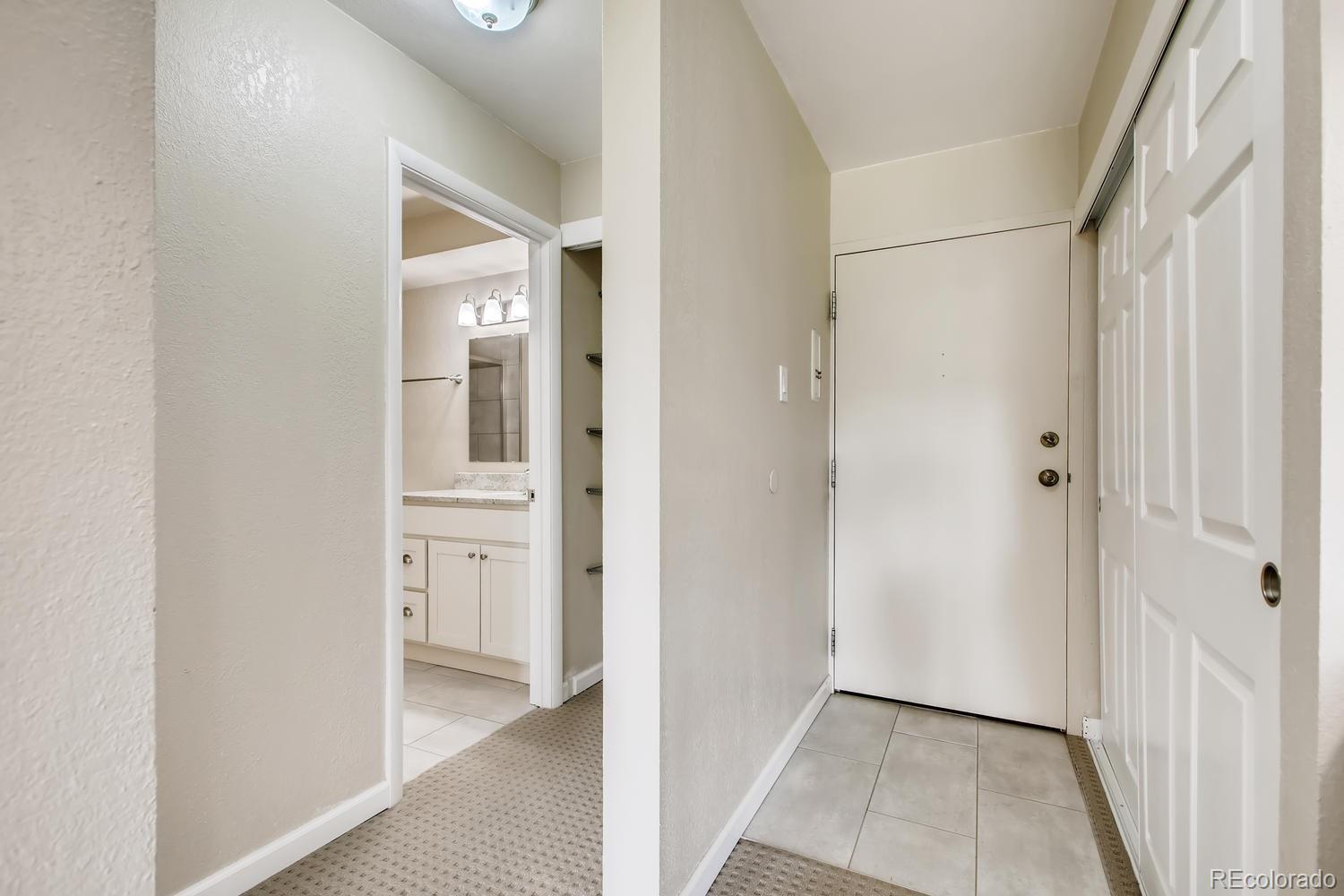 9340 Center Avenue, Unit 6B Denver, CO 80247 - Photo 13 of 40 a view of a hallway with wooden floor and closet