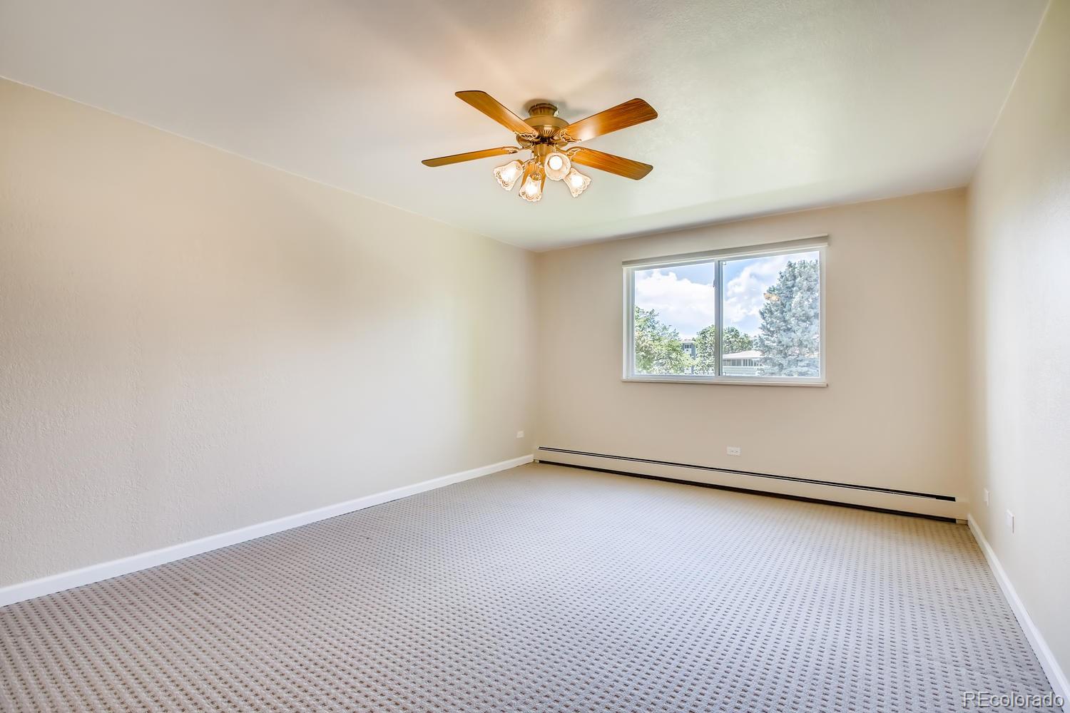 9340 Center Avenue, Unit 6B Denver, CO 80247 - Photo 19 of 40 an empty room with window and ceiling fan