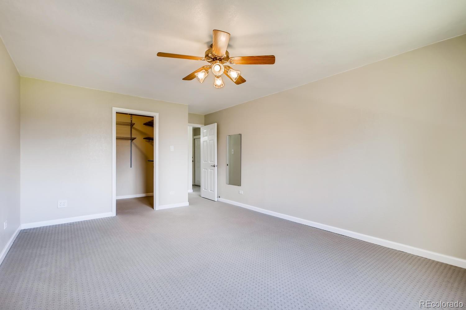 9340 Center Avenue, Unit 6B Denver, CO 80247 - Photo 20 of 40 an empty room with closet and a chandelier fan