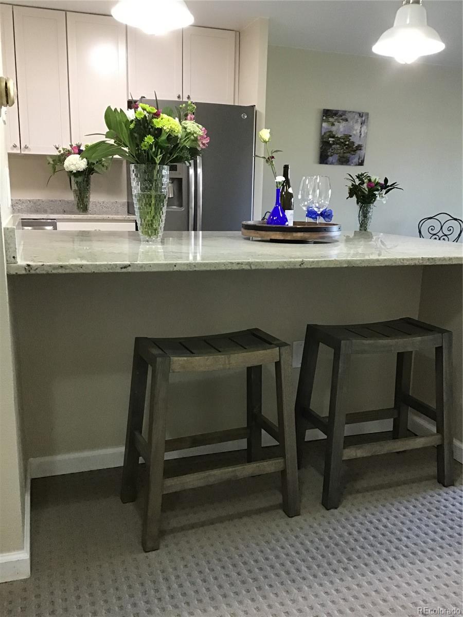 9340 Center Avenue, Unit 6B Denver, CO 80247 - Photo 2 of 40 a kitchen with a table and chairs in it
