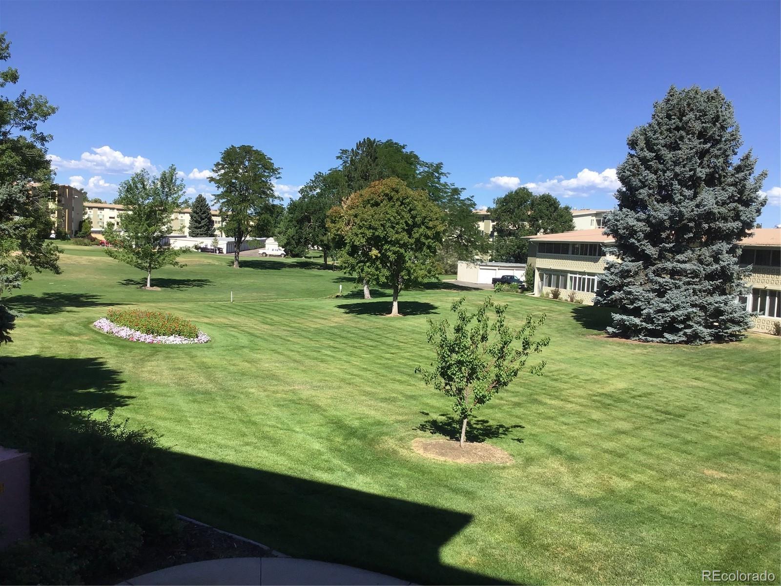 9340 Center Avenue, Unit 6B Denver, CO 80247 - Photo 30 of 40 a garden with trees in the background