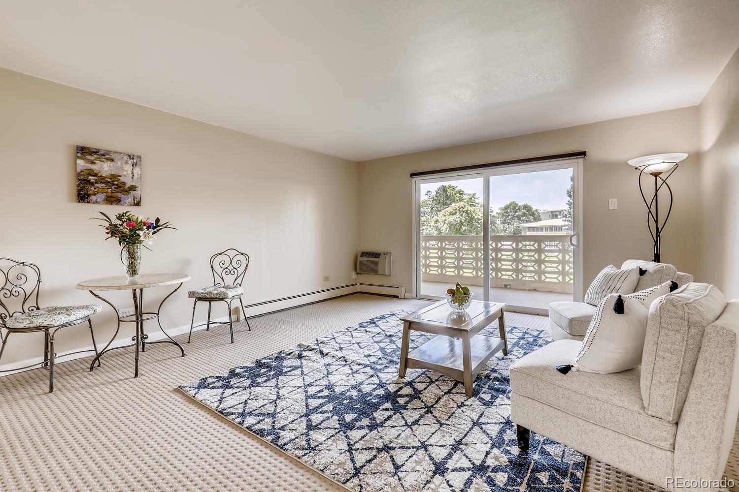 9340 Center Avenue, Unit 6B Denver, CO 80247 - Photo 3 of 40 a living room with furniture floor to ceiling window and a table