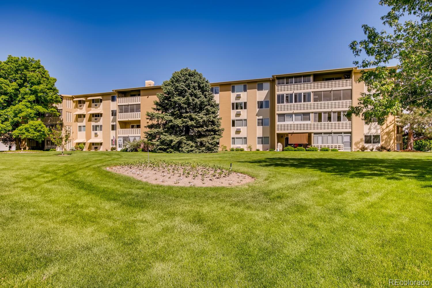 9340 Center Avenue, Unit 6B Denver, CO 80247 - Photo 34 of 40 a view of a building with a big yard and large trees