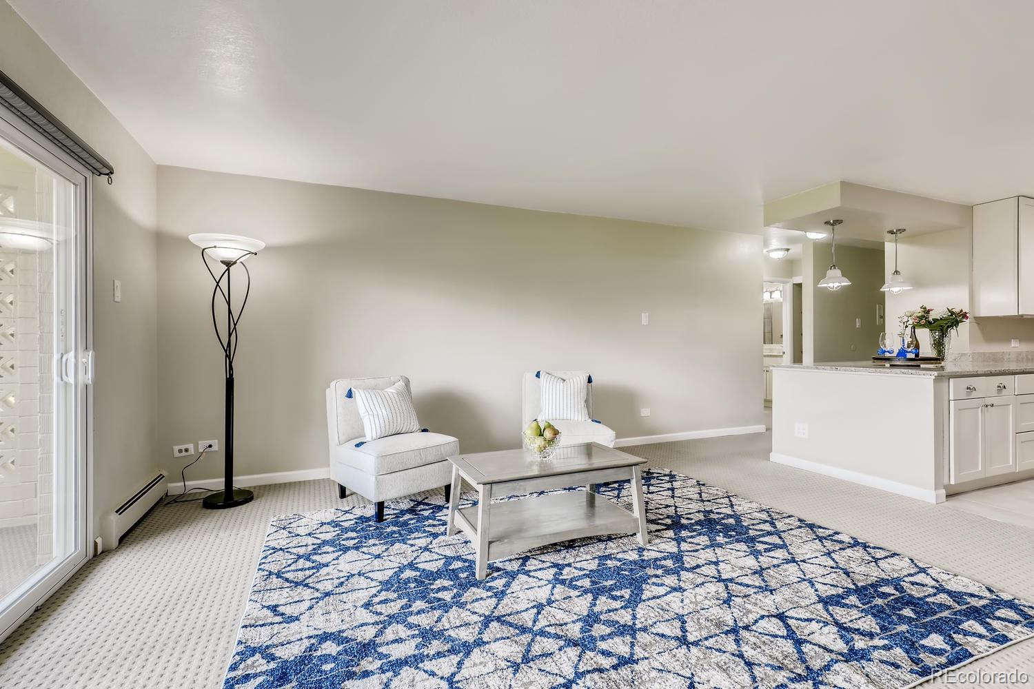 9340 Center Avenue, Unit 6B Denver, CO 80247 - Photo 4 of 40 a living room with furniture and a rug
