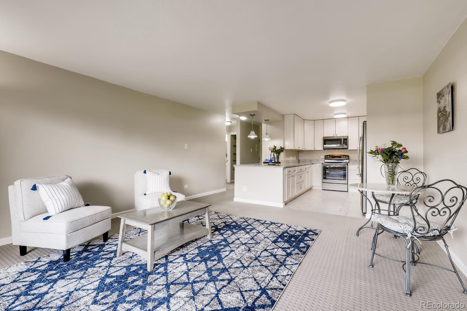 9340 Center Avenue, Unit 6B Denver, CO 80247 - Photo 7 of 40 a living room with furniture and kitchen view