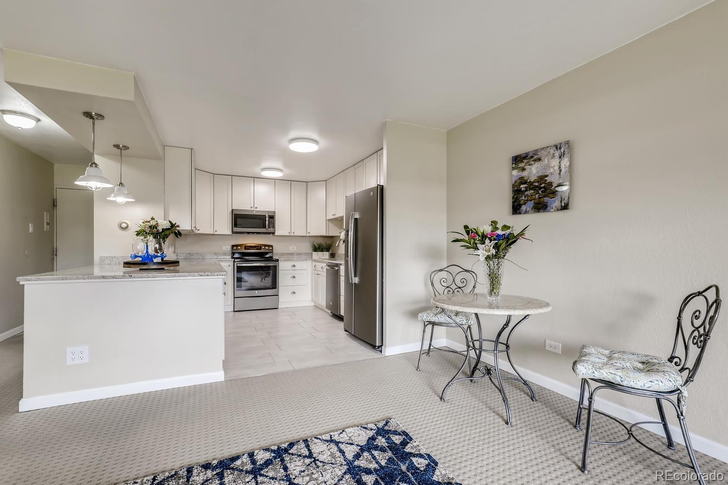 9340 Center Avenue, Unit 6B Denver, CO 80247 - Photo 8 of 40 a living room with furniture and kitchen view