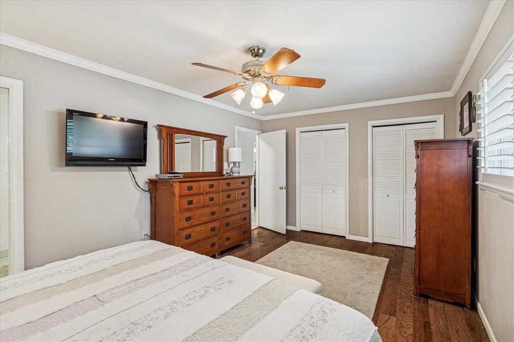 4209 Bilglade Road Fort Worth, TX 76109 - Photo 16 of 24 a bedroom with a bed and a flat screen tv