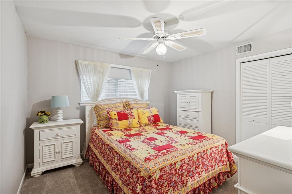 4209 Bilglade Road Fort Worth, TX 76109 - Photo 18 of 24 a bedroom with a bed and a chandelier