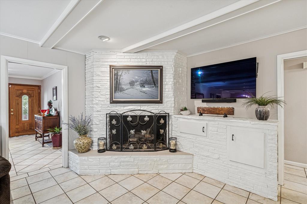 4209 Bilglade Road Fort Worth, TX 76109 - Photo 7 of 24 a living room with furniture a flat screen tv and a fireplace