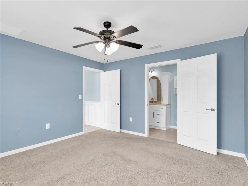731 Hadley Place West Naples, FL 34104 - Photo 21 of 30 Primary Bedroom With Ceiling Fan and En-Suite Bathroom