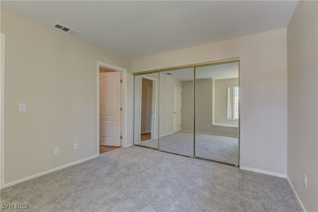 3145 East Flamingo Road, Unit 2080 Las Vegas, NV 89121 - Photo 17 of 26 Unfurnished bedroom featuring carpet floors, baseboards, and a closet