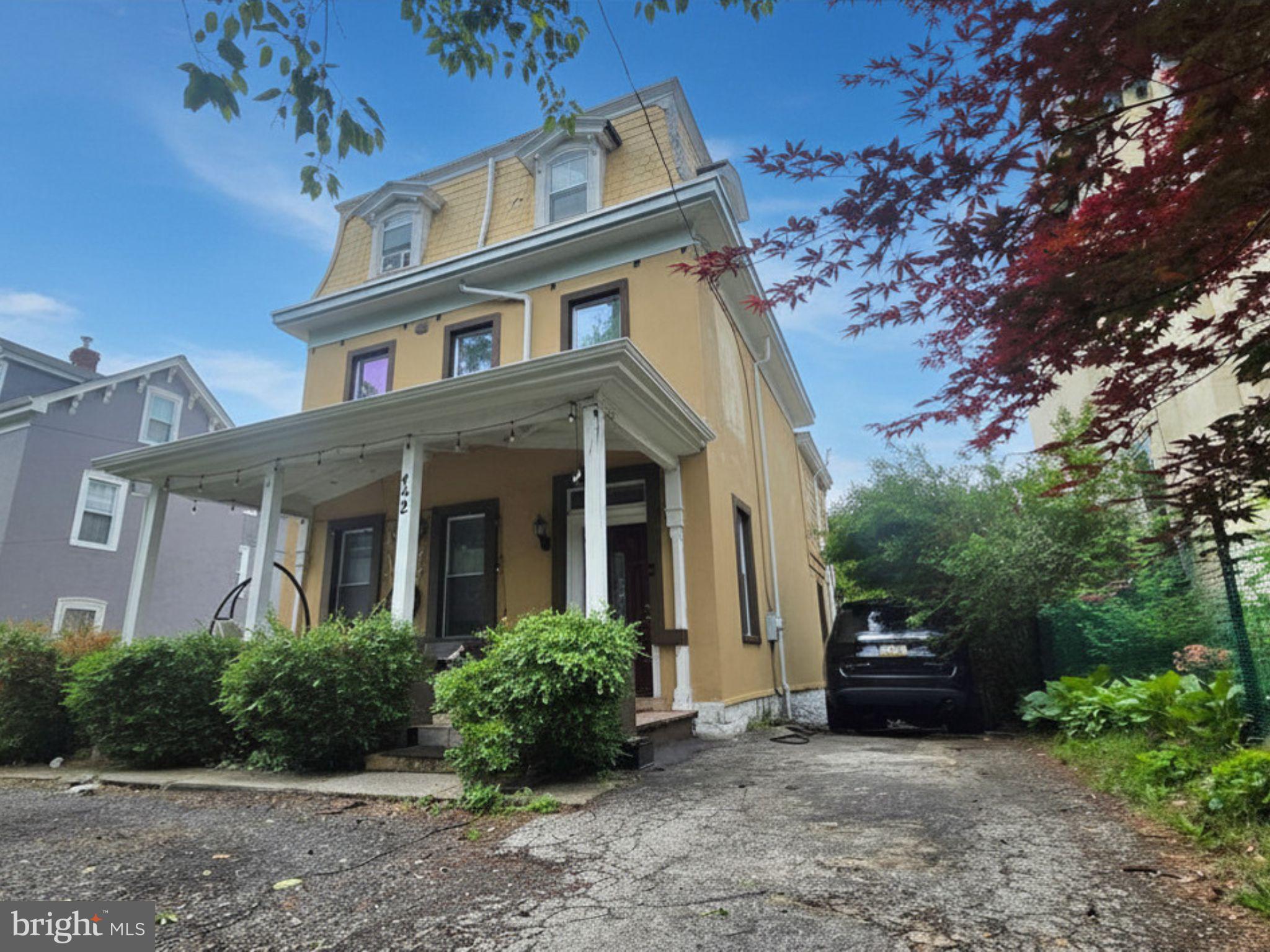 242 Church Road Elkins Park, PA 19027 - Photo 29 of 29 Charming yellow home with lush greenery.