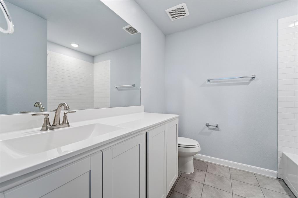 343 Caviar Road Waxahachie, TX 75165 - Photo 17 of 22 a bathroom with a sink a toilet and a mirror