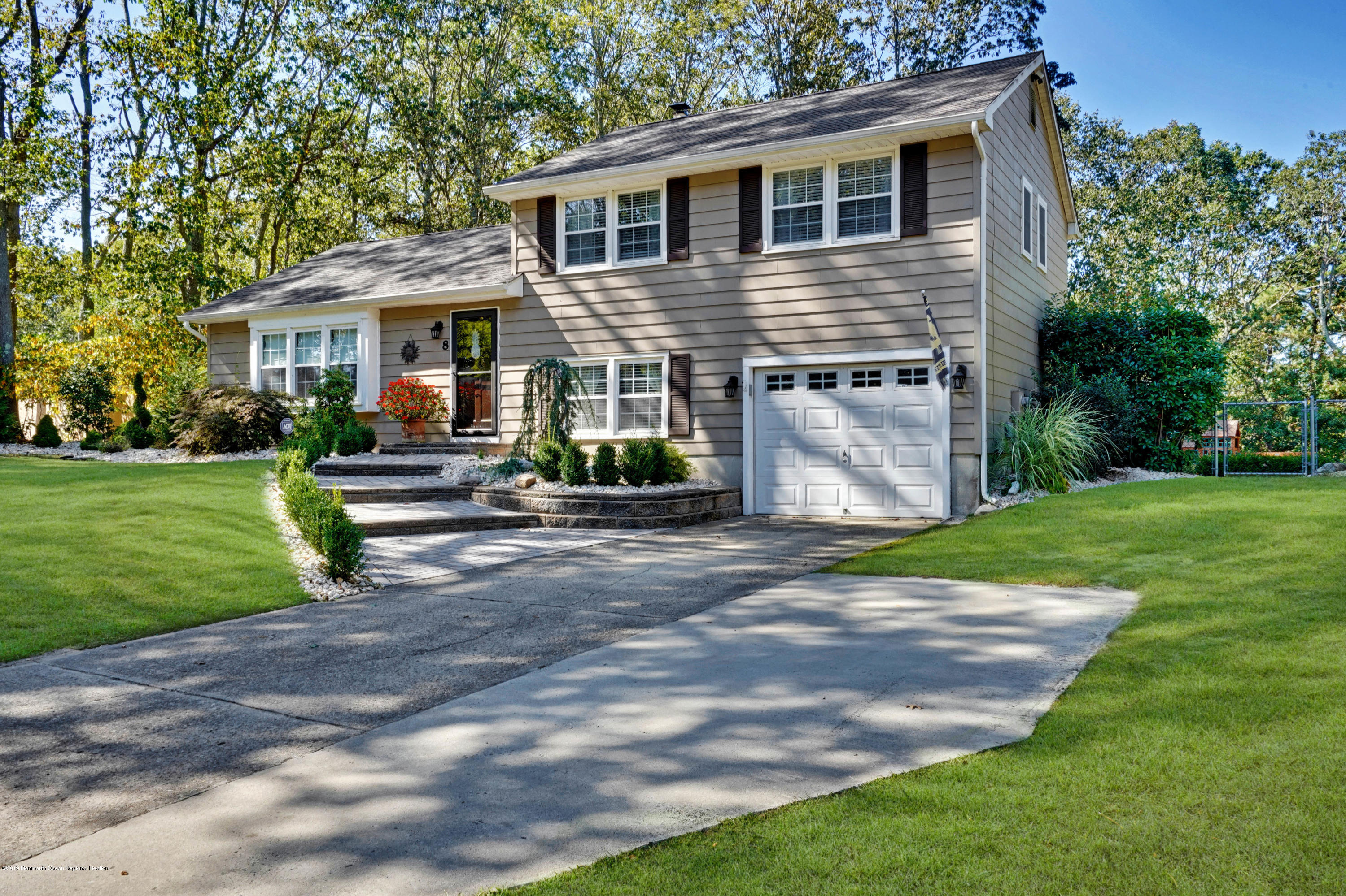 8 Dunbarton Road Jackson, NJ 08527 - Photo 3 of 34 a front view of a house with a yard