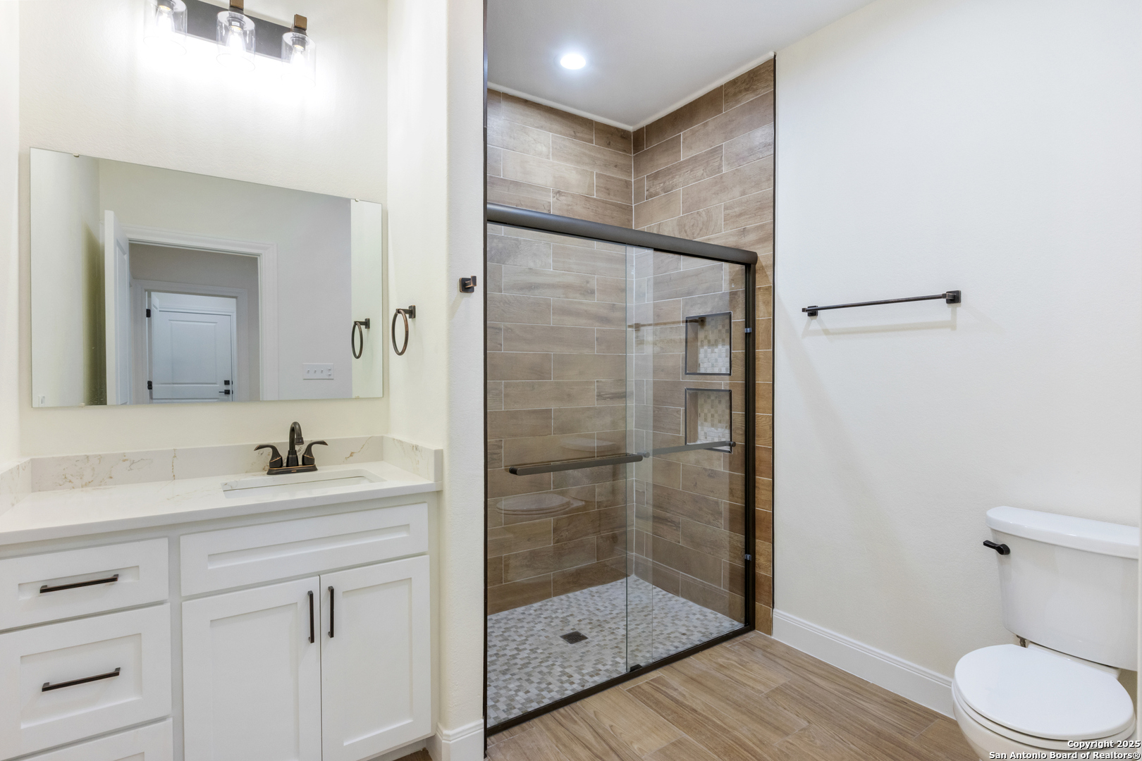 32 Trophy Lane Poteet, TX 78065 - Photo 15 of 47 a bathroom with a shower sink vanity and toilet
