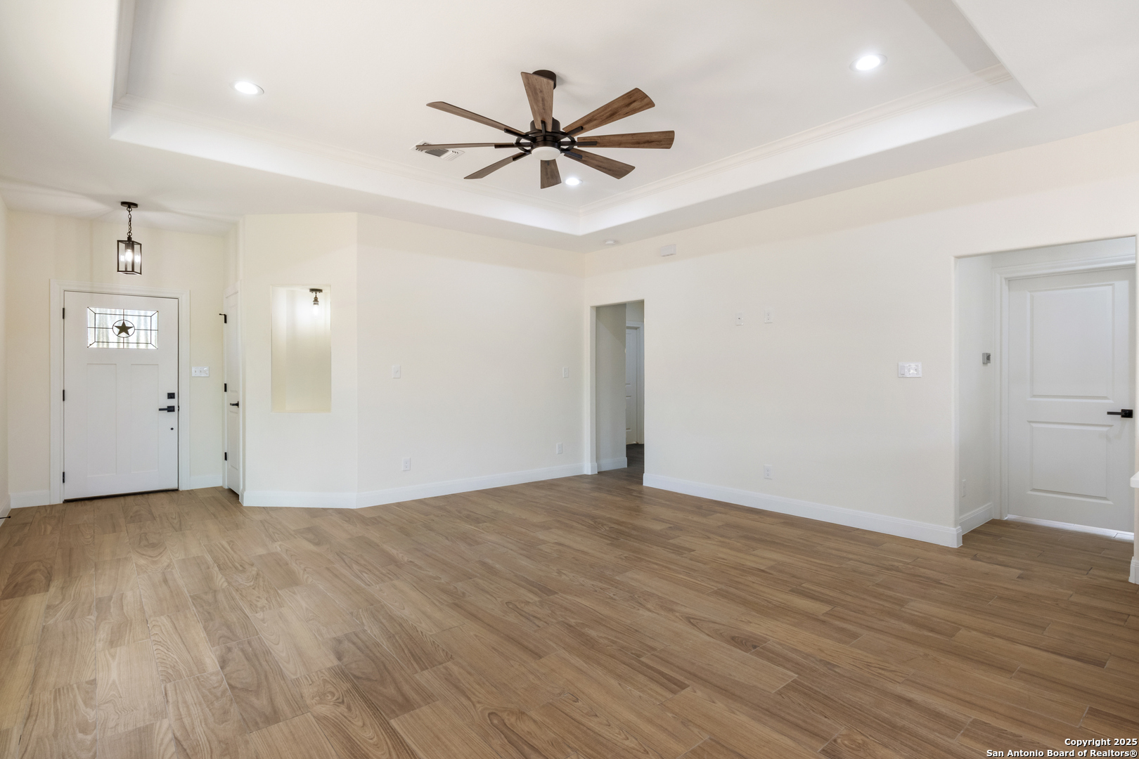 32 Trophy Lane Poteet, TX 78065 - Photo 20 of 47 a view of a livingroom with a ceiling fan wooden floor and a ceiling fan