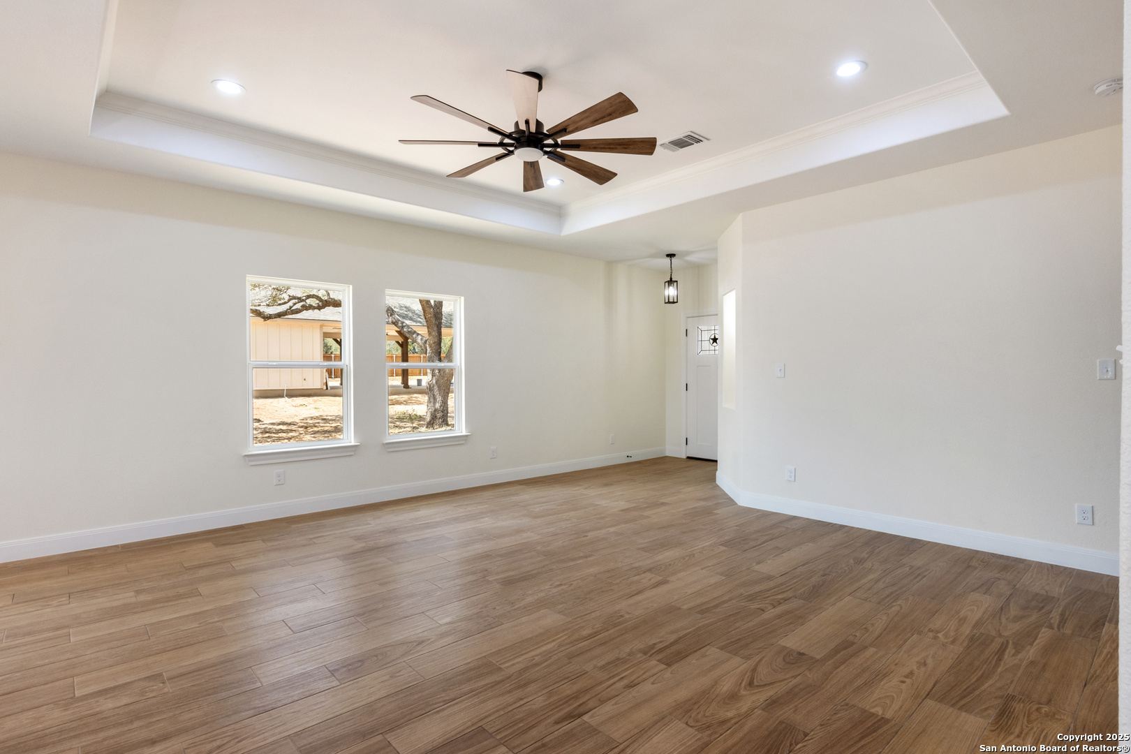 32 Trophy Lane Poteet, TX 78065 - Photo 21 of 47 a view of an empty room with wooden floor and a window