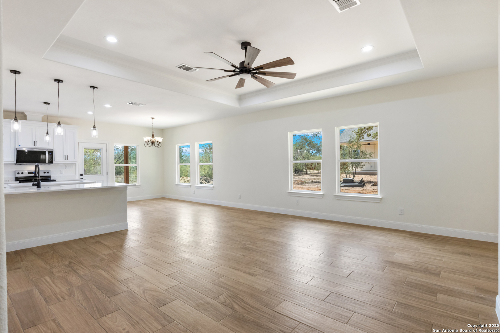 32 Trophy Lane Poteet, TX 78065 - Photo 22 of 47 a view of an empty room with window and wooden floor