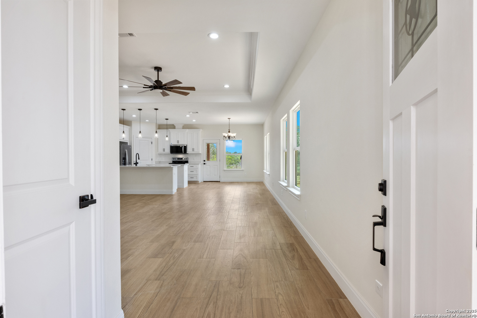 32 Trophy Lane Poteet, TX 78065 - Photo 27 of 47 a view of a hallway with wooden floor and a kitchen