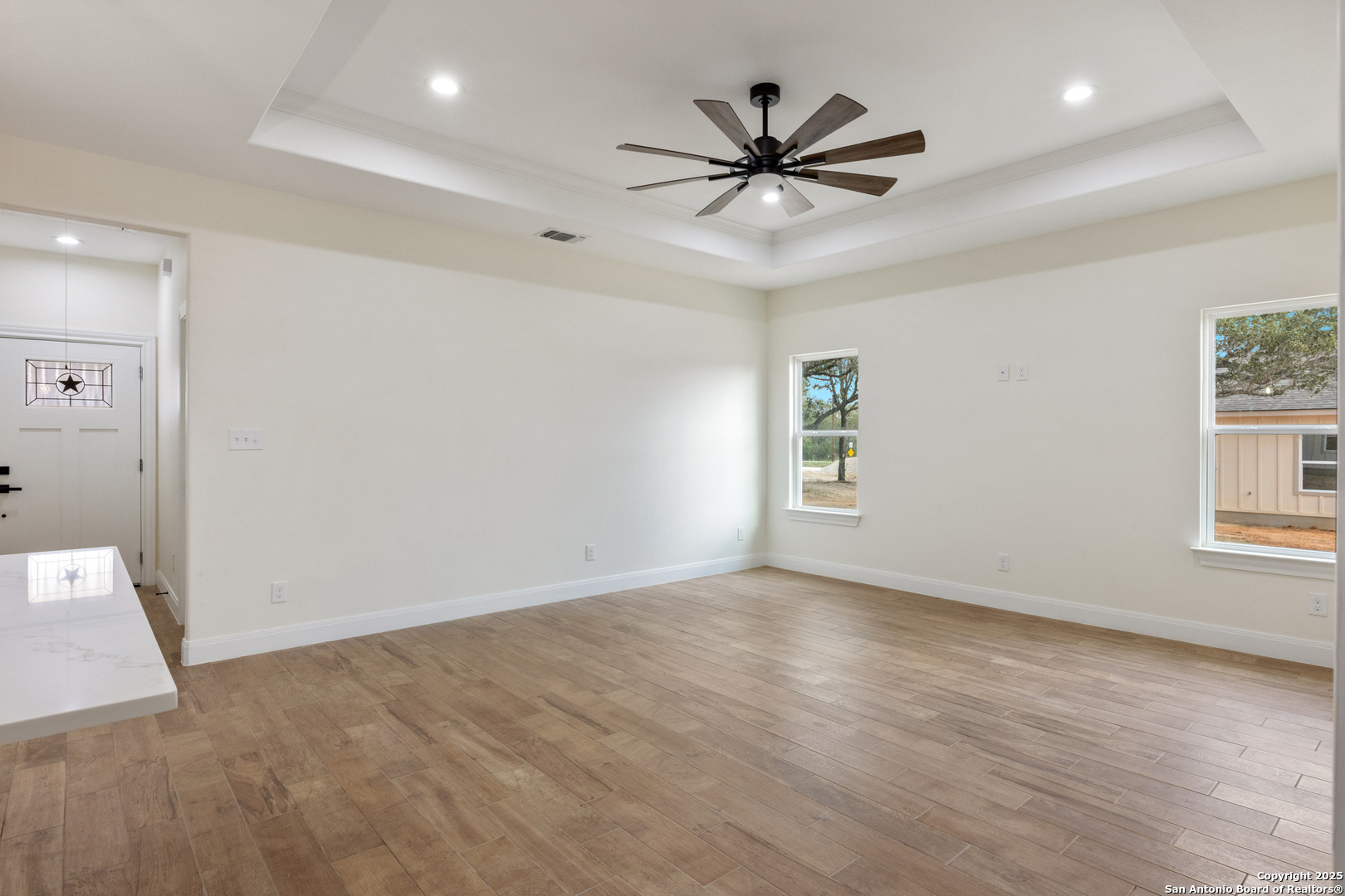32 Trophy Lane Poteet, TX 78065 - Photo 31 of 47 wooden floor in an empty room with a window