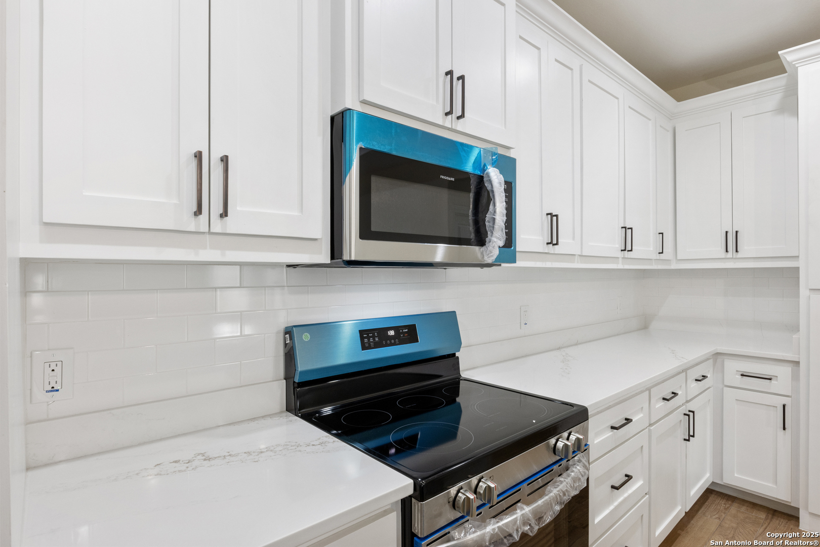 32 Trophy Lane Poteet, TX 78065 - Photo 33 of 47 a kitchen with stainless steel appliances a stove a microwave and cabinets