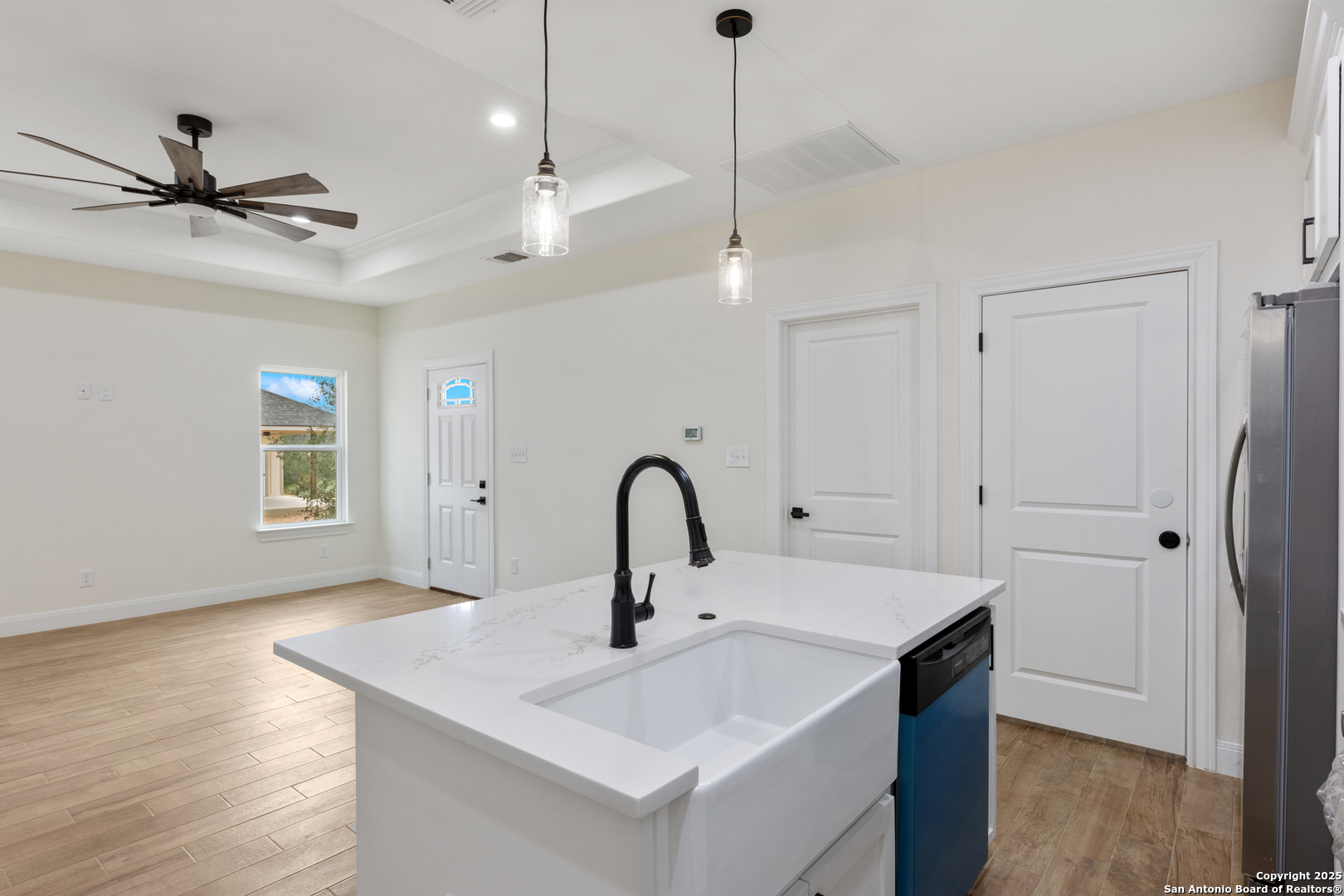 32 Trophy Lane Poteet, TX 78065 - Photo 34 of 47 a kitchen with a sink a counter space and wooden floor