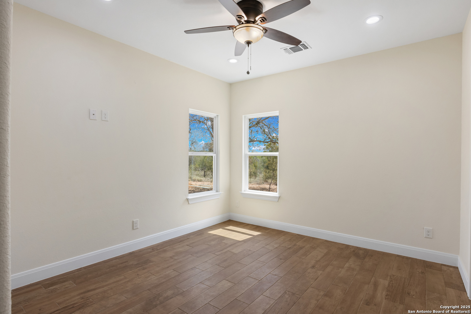 32 Trophy Lane Poteet, TX 78065 - Photo 36 of 47 an empty room with a window and a fan
