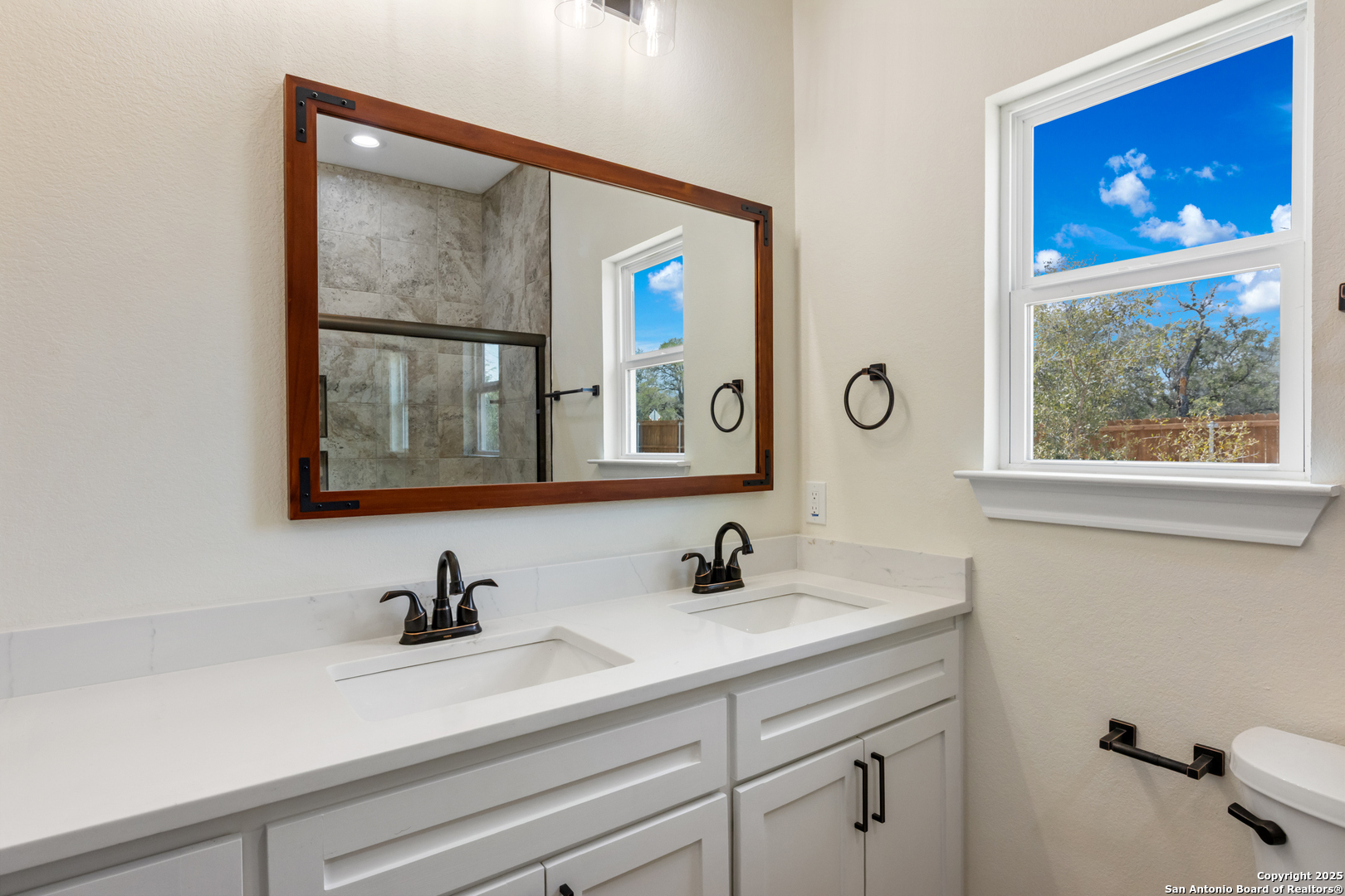 32 Trophy Lane Poteet, TX 78065 - Photo 37 of 47 a bathroom with a sink and a mirror