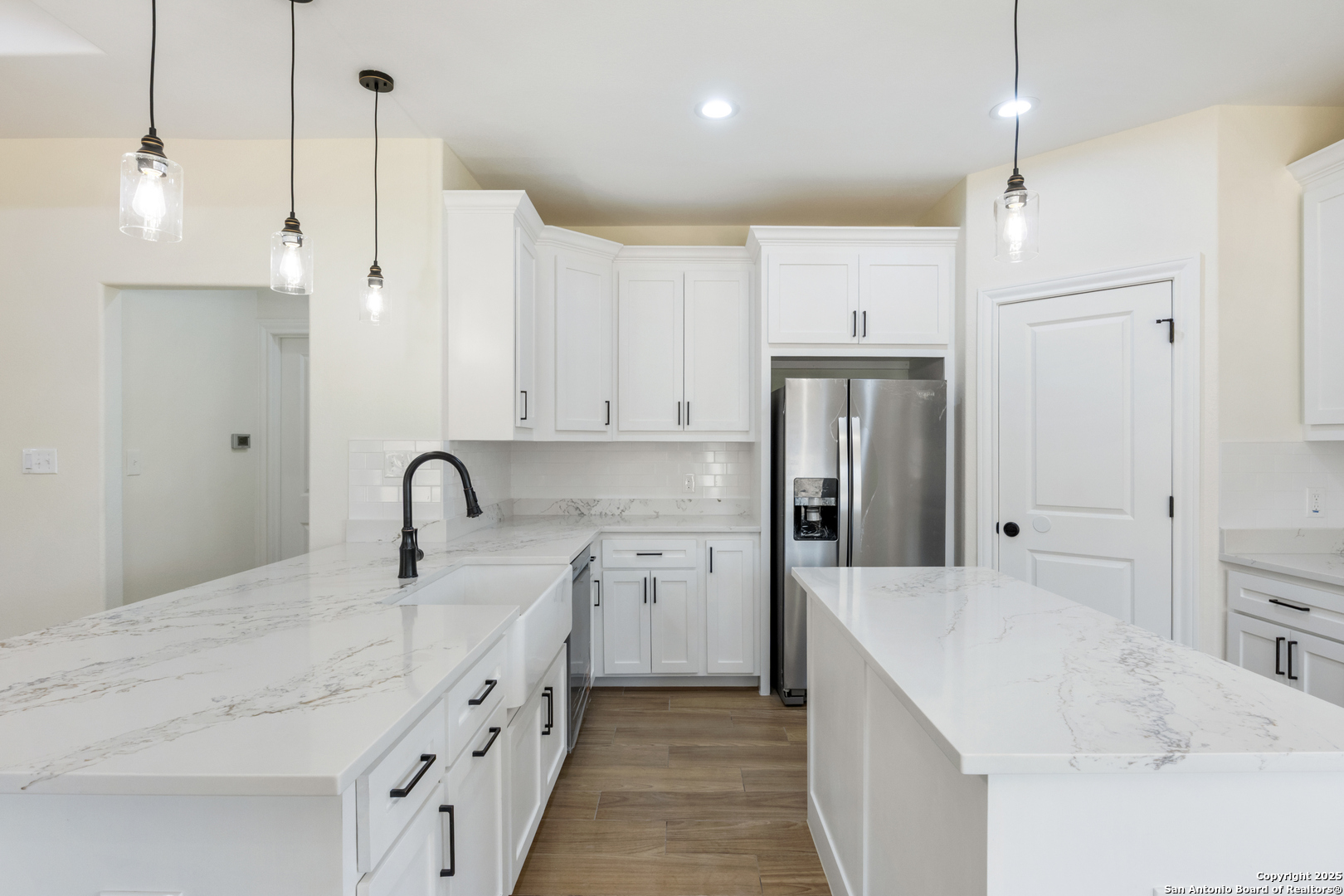 32 Trophy Lane Poteet, TX 78065 - Photo 5 of 47 a large white kitchen with a sink a refrigerator and a stove