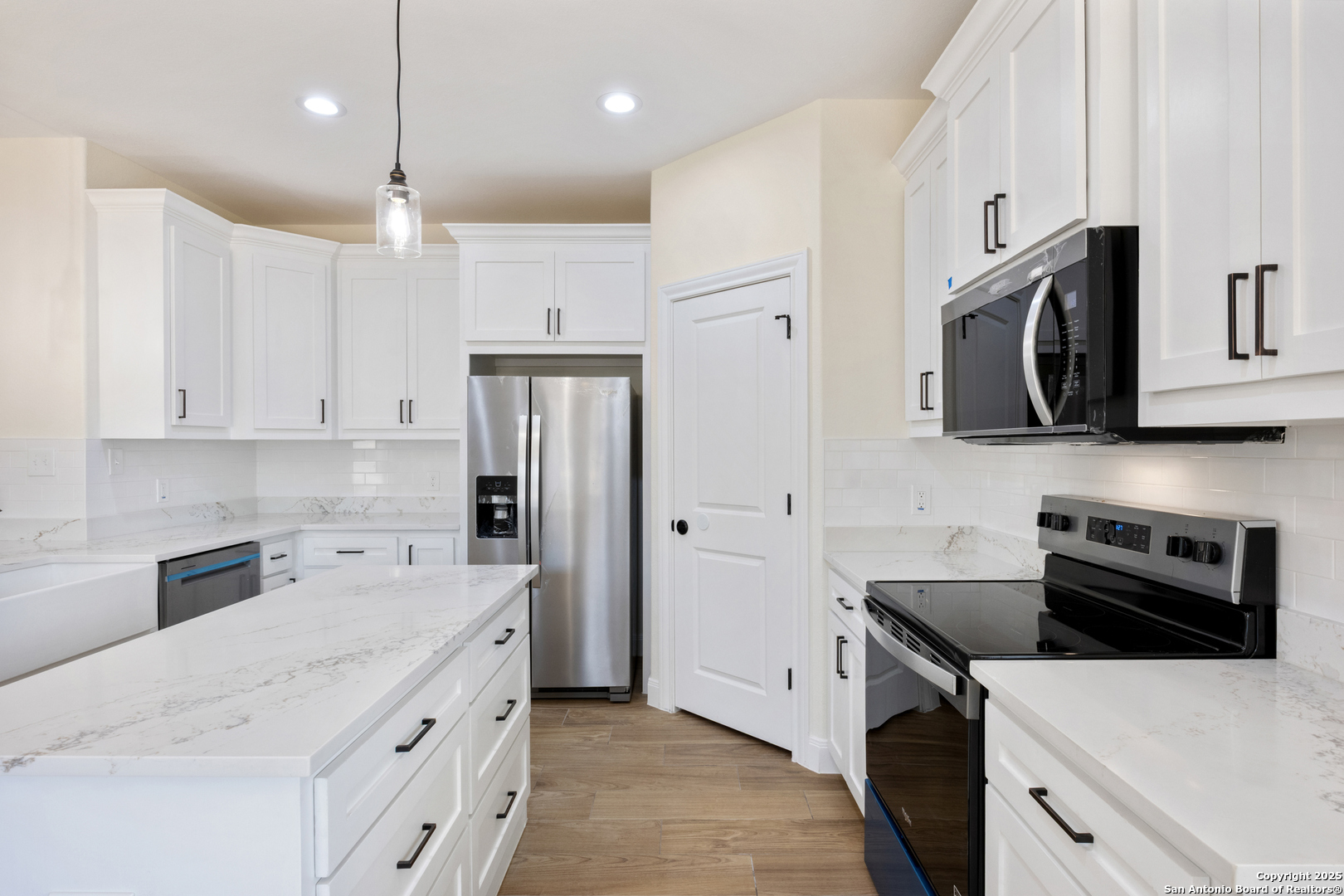 32 Trophy Lane Poteet, TX 78065 - Photo 6 of 47 a kitchen with stainless steel appliances a stove microwave sink refrigerator and cabinets