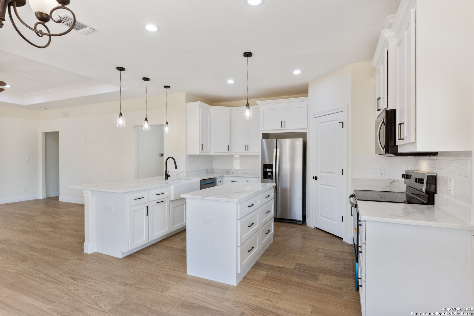32 Trophy Lane Poteet, TX 78065 - Photo 8 of 47 a kitchen with white cabinets and stainless steel appliances
