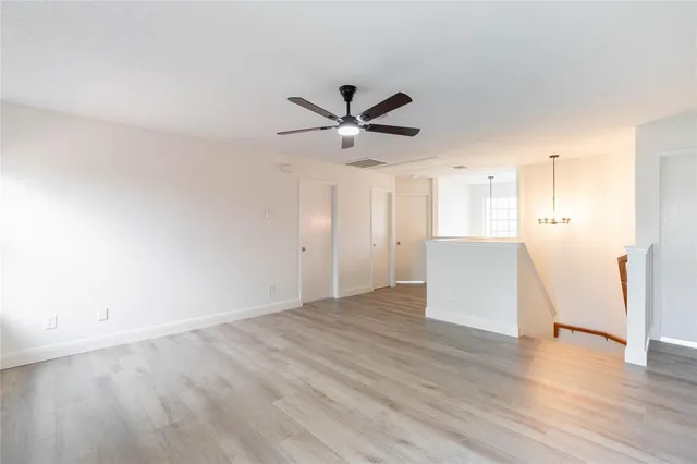 a view of a kitchen with a sink and a refrigerator