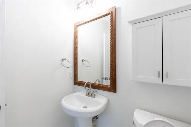 a bathroom with a sink toilet