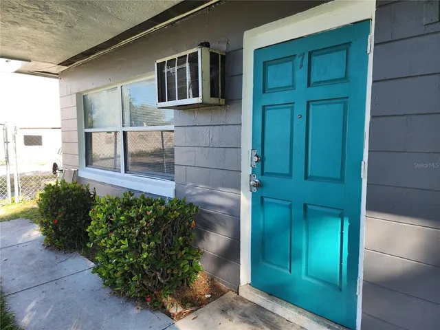 a view of a kitchen with wooden floor and electronic appliances