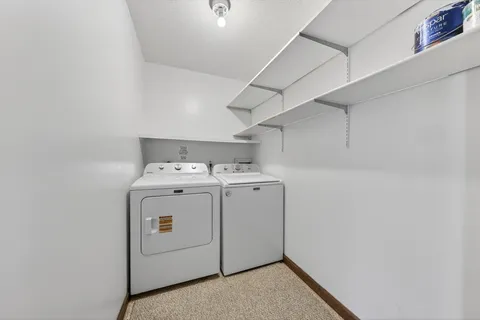 a spacious bedroom with a bed and a mirror