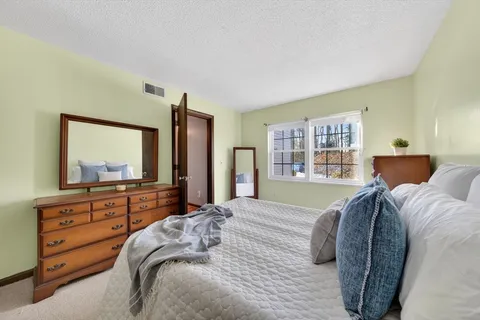 a bedroom with a large bed and a dresser