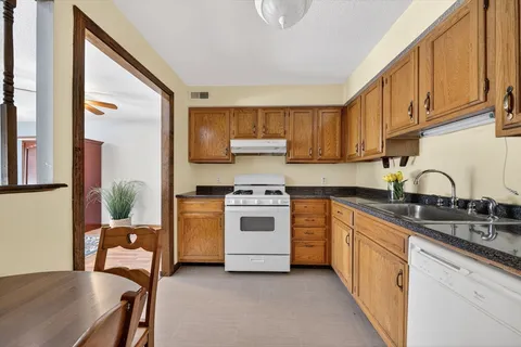a kitchen with a sink a stove and refrigerator