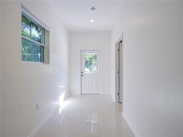 en empty room with windows and closet