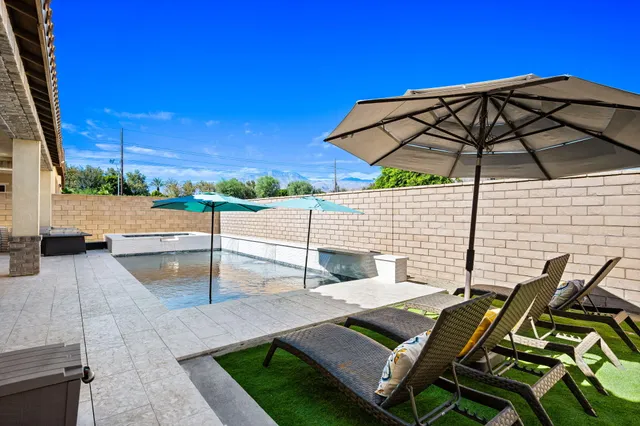 a view of a backyard with sitting area