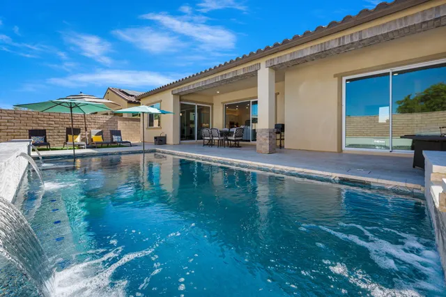 a view of a swimming pool with outdoor seating
