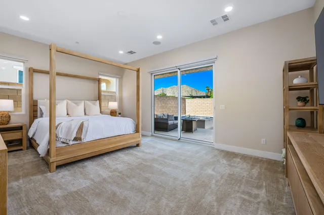 a bedroom with a bed and a view of kitchen