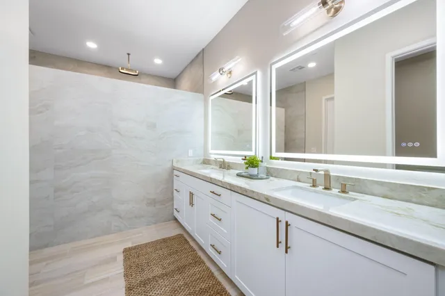 a bathroom with a double vanity sink and a mirror