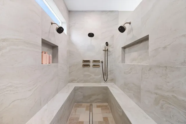 a bathroom with a bathtub and shower