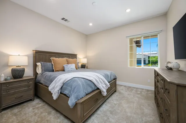 a spacious bedroom with a bed and a window